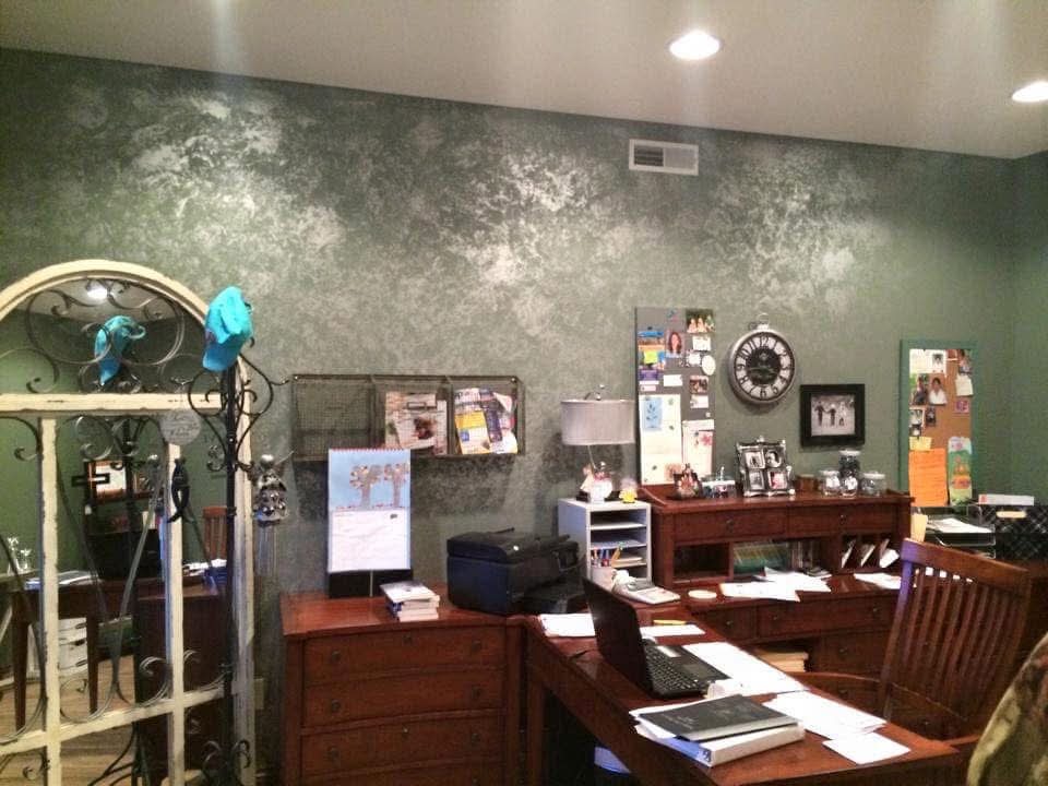 Custom faux-finish textured sage green accent wall in a home office